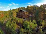 Drone Shot of the front of the cabin showing all the windows to enjoy that view 
